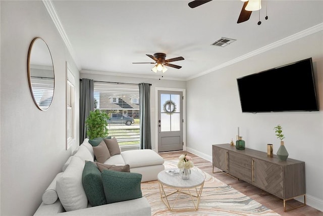2409 Corinne Dr, Chalmette, LA 70043 - living area with ceiling fan, light wood-style floors, baseboards, and crown molding