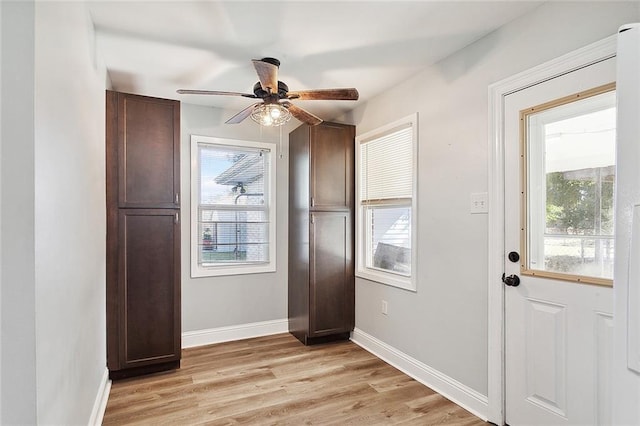 2409 Corinne Dr, Chalmette, LA 70043 - doorway to outside featuring ceiling fan, light wood-style flooring, and baseboards