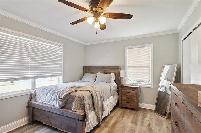 2409 Corinne Dr, Chalmette, LA 70043 - bedroom with ornamental molding, baseboards, light wood-type flooring, ceiling fan, and a closet