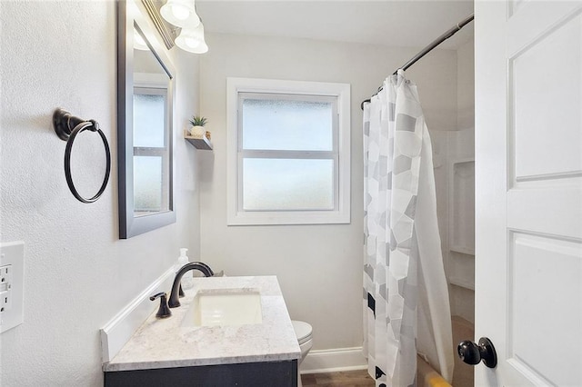 2409 Corinne Dr, Chalmette, LA 70043 - full bathroom with vanity, toilet, shower / bath combination with curtain, and baseboards