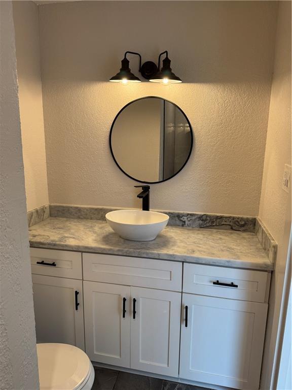 1005 David Dr, Metairie, LA 70003 - bathroom featuring vanity and a textured wall