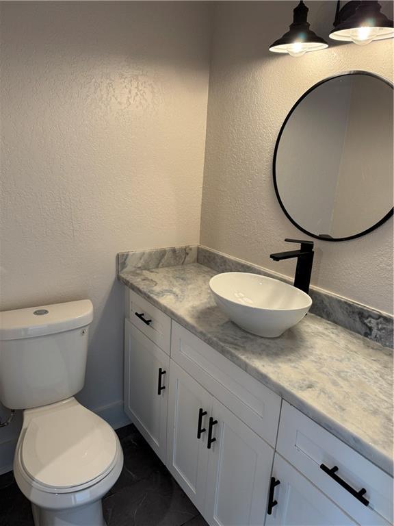 1005 David Dr, Metairie, LA 70003 - bathroom featuring vanity and a textured wall