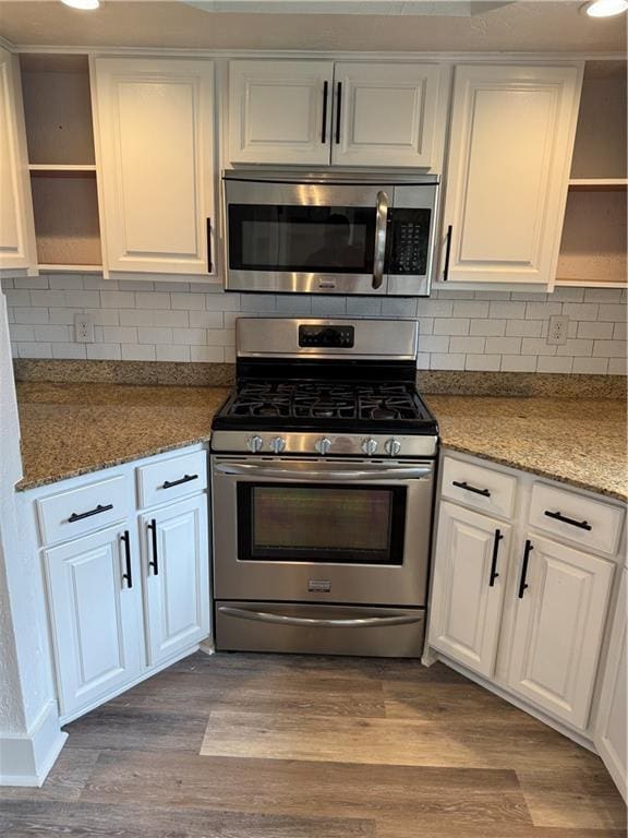 1005 David Dr, Metairie, LA 70003 - kitchen featuring open shelves, appliances with stainless steel finishes, white cabinetry, dark wood finished floors, and recessed lighting