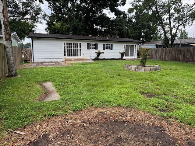 1005 David Dr, Metairie, LA 70003 - rear view of house with a fenced backyard