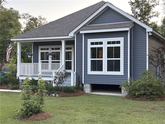 72163 Indian Trail Rd, Abita Springs, LA 70420 - view of front of home with a porch, a front lawn, and roof with shingles