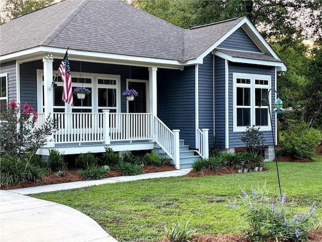 72163 Indian Trail Rd, Abita Springs, LA 70420 - view of front of house with a porch, a shingled roof, and a front lawn