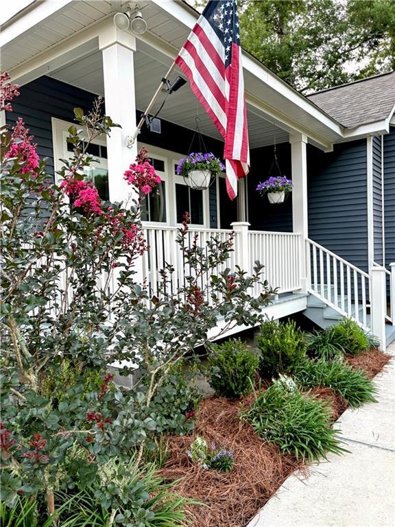 72163 Indian Trail Rd, Abita Springs, LA 70420 - view of home's exterior featuring covered porch and a shingled roof