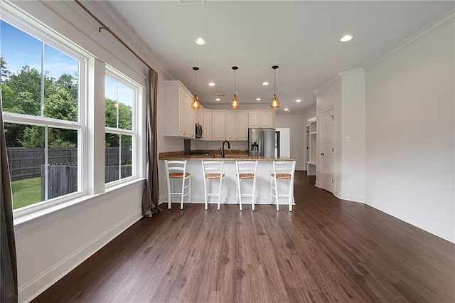 72163 Indian Trail Rd, Abita Springs, LA 70420 - kitchen with appliances with stainless steel finishes, baseboards, dark wood-style floors, a peninsula, and recessed lighting