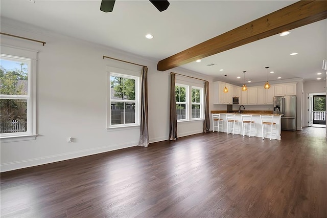 72163 Indian Trail Rd, Abita Springs, LA 70420 - unfurnished living room with a ceiling fan, plenty of natural light, baseboards, beamed ceiling, and recessed lighting