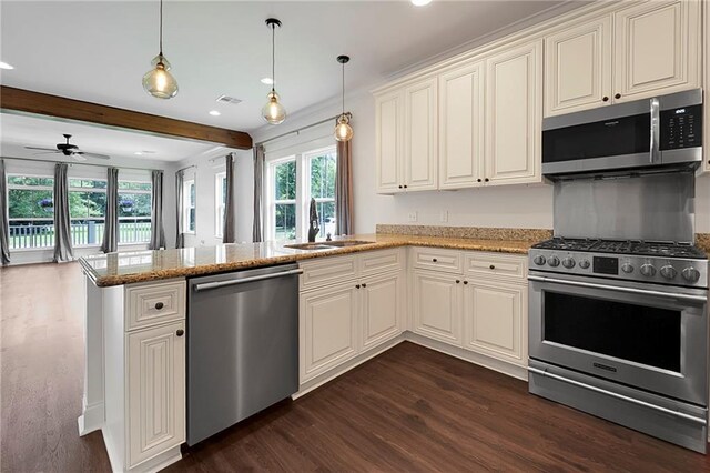72163 Indian Trail Rd, Abita Springs, LA 70420 - kitchen with appliances with stainless steel finishes, a sink, dark wood-style flooring, a peninsula, and beamed ceiling