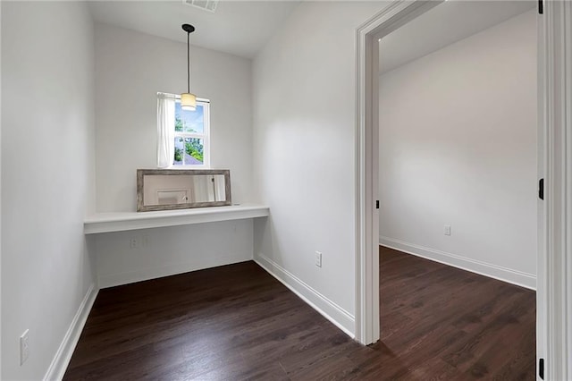 72163 Indian Trail Rd, Abita Springs, LA 70420 - unfurnished dining area featuring dark wood-style flooring and baseboards