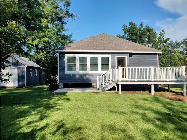 72163 Indian Trail Rd, Abita Springs, LA 70420 - rear view of house with a deck, a lawn, and roof with shingles