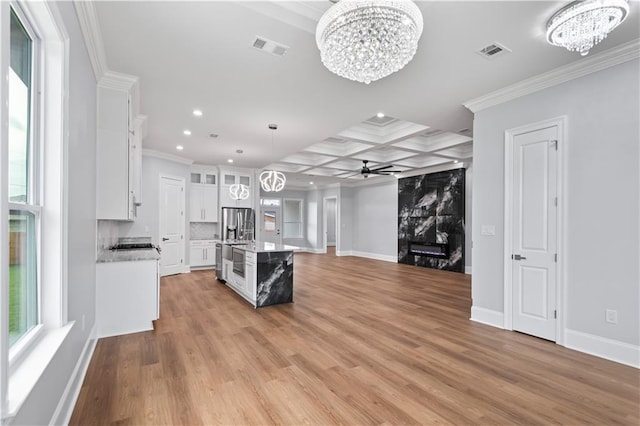 1208 Lucille Ave, Metairie, LA 70003 - kitchen with a chandelier, stainless steel fridge with ice dispenser, white cabinets, a ceiling fan, and ornamental molding