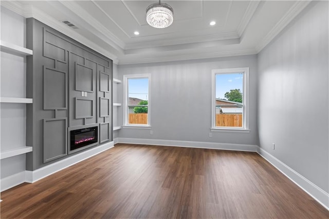 1208 Lucille Ave, Metairie, LA 70003 - unfurnished living room with healthy amount of natural light, dark wood-style floors, ornamental molding, a tray ceiling, and a chandelier