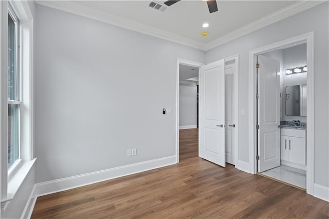 1208 Lucille Ave, Metairie, LA 70003 - unfurnished bedroom featuring wood finished floors, ornamental molding, baseboards, recessed lighting, and ensuite bathroom