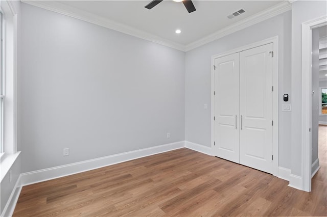 1208 Lucille Ave, Metairie, LA 70003 - unfurnished bedroom with wood finished floors, ornamental molding, baseboards, a closet, and a ceiling fan