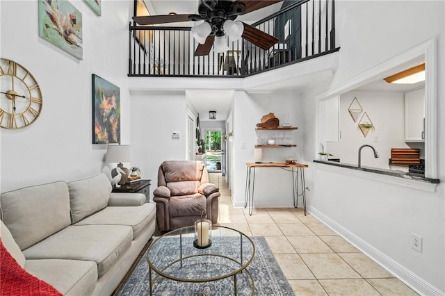 120 W Pineridge St Unit 120, Mandeville, LA 70448 - living room with ceiling fan, light tile patterned flooring, and a high ceiling