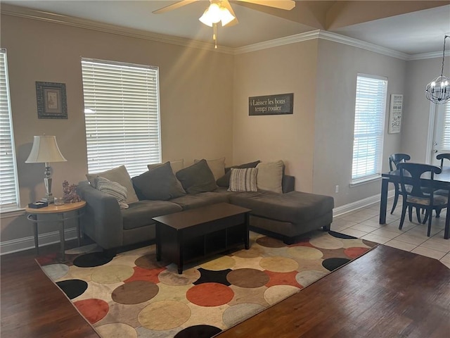 4441 Burbank Dr Unit 308, Baton Rouge, LA 70820 - living room with light wood-style flooring, baseboards, ceiling fan, a chandelier, and crown molding