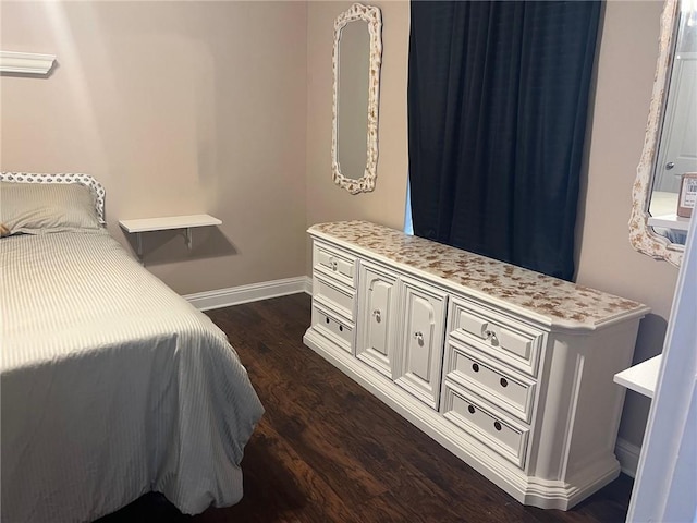 4441 Burbank Dr Unit 308, Baton Rouge, LA 70820 - bedroom featuring dark wood finished floors and baseboards