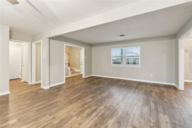 4509 Purdue Dr, Metairie, LA 70003 - spare room with wood finished floors, stairway, and baseboards