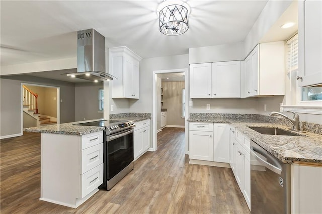 4509 Purdue Dr, Metairie, LA 70003 - kitchen featuring island exhaust hood, stainless steel appliances, a sink, light wood finished floors, and baseboards