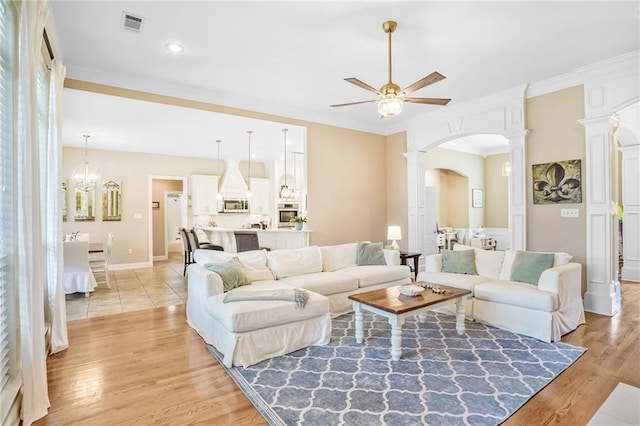 1067 Scarlet Oak Ln, Mandeville, LA 70448 - living area featuring a ceiling fan, arched walkways, decorative columns, light wood finished floors, and recessed lighting