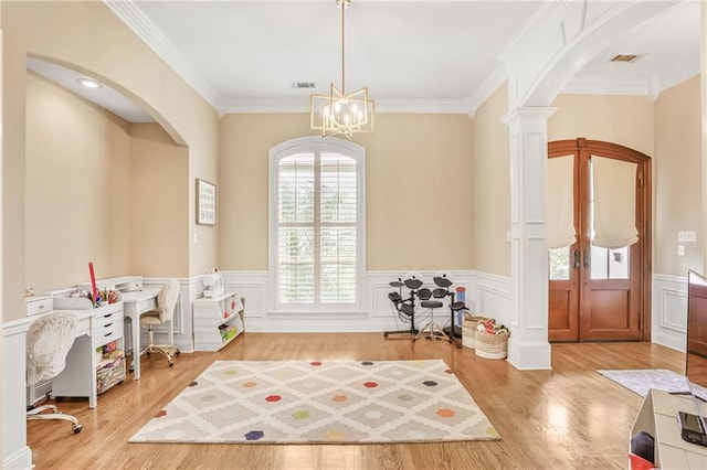 1067 Scarlet Oak Ln, Mandeville, LA 70448 - playroom featuring arched walkways, a wainscoted wall, ornamental molding, ornate columns, and wood finished floors