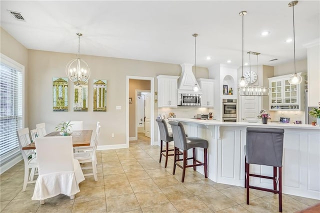1067 Scarlet Oak Ln, Mandeville, LA 70448 - kitchen featuring stainless steel appliances, a chandelier, tasteful backsplash, light countertops, and white cabinetry