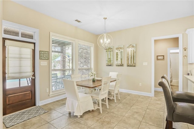 1067 Scarlet Oak Ln, Mandeville, LA 70448 - dining space featuring a chandelier, light tile patterned floors, and baseboards