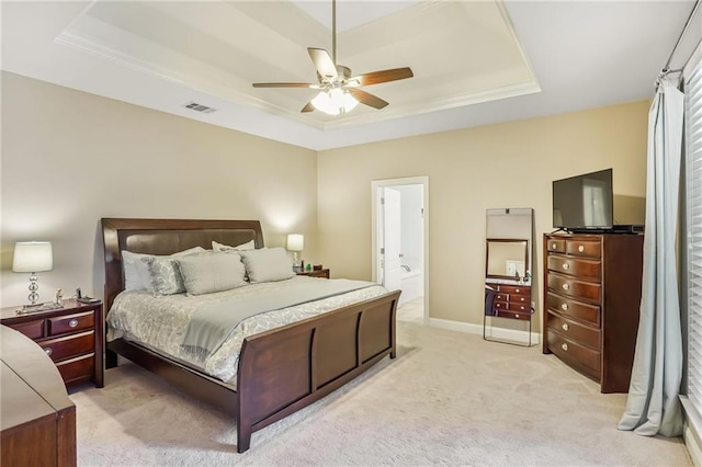 1067 Scarlet Oak Ln, Mandeville, LA 70448 - bedroom featuring a raised ceiling, light carpet, ceiling fan, baseboards, and ensuite bath