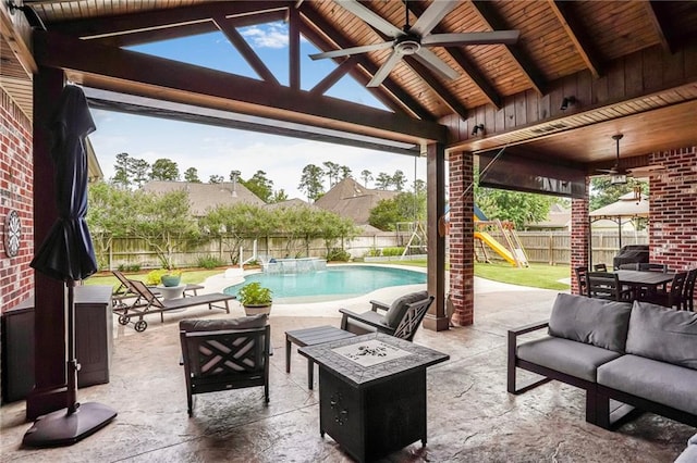 1067 Scarlet Oak Ln, Mandeville, LA 70448 - fenced backyard with an outdoor living space with a fire pit, ceiling fan, a playground, and a patio area