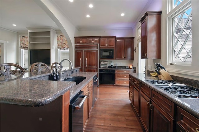 5936 Chestnut St, New Orleans, LA 70115 - kitchen featuring black appliances, a sink, ornamental molding, arched walkways, and dark wood-type flooring