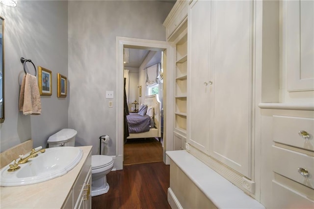 5936 Chestnut St, New Orleans, LA 70115 - ensuite bathroom featuring toilet, wood finished floors, and vanity