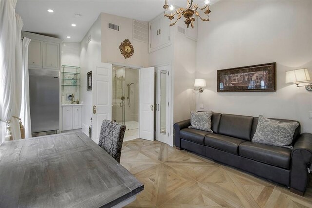 5936 Chestnut St, New Orleans, LA 70115 - living room featuring a chandelier, a high ceiling, recessed lighting, and baseboards