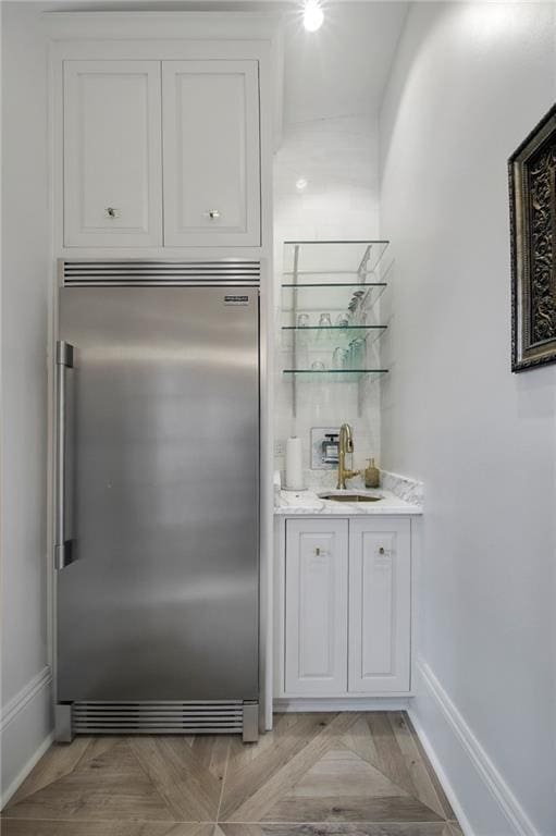 5936 Chestnut St, New Orleans, LA 70115 - indoor wet bar featuring stainless steel built in refrigerator and baseboards