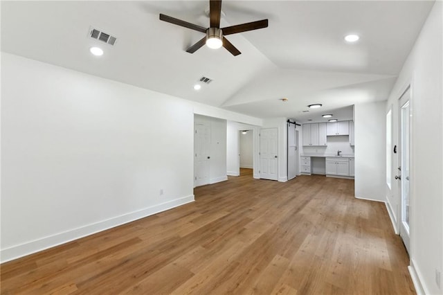 35210 Windsor Dr, Slidell, LA 70460 - unfurnished living room with ceiling fan, lofted ceiling, light wood-style floors, baseboards, and a sink