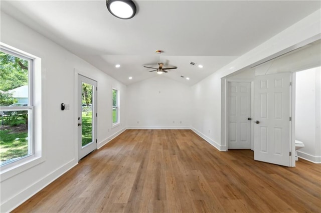 35210 Windsor Dr, Slidell, LA 70460 - empty room featuring healthy amount of natural light, light wood-style flooring, ceiling fan, baseboards, and lofted ceiling