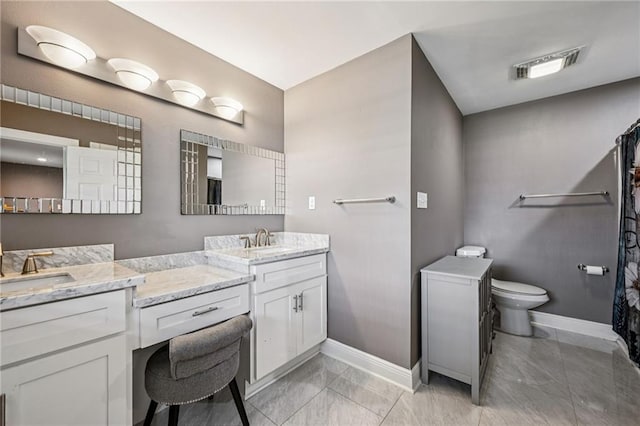 3816 Jean Lafitte Pkwy, Chalmette, LA 70043 - full bathroom with baseboards, double vanity, toilet, and marble look tile flooring