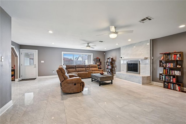 3816 Jean Lafitte Pkwy, Chalmette, LA 70043 - living room featuring baseboards, a fireplace, a ceiling fan, recessed lighting, and light marble finish flooring