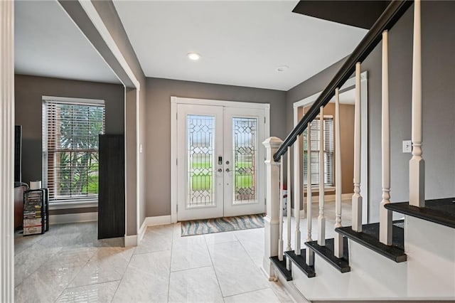 3816 Jean Lafitte Pkwy, Chalmette, LA 70043 - foyer with stairway, french doors, baseboards, marble look tile flooring, and recessed lighting