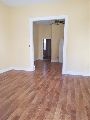 2607 Soniat St, New Orleans, LA 70115 - unfurnished room with wood finished floors and baseboards