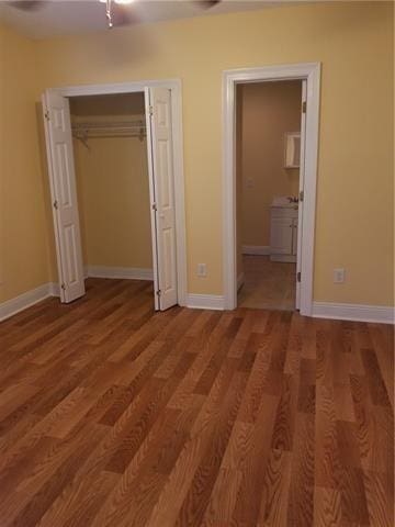 2607 Soniat St, New Orleans, LA 70115 - unfurnished bedroom featuring wood finished floors, a closet, ensuite bath, and a ceiling fan