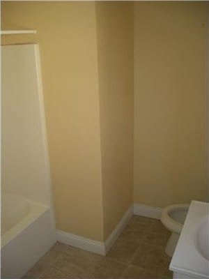 2607 Soniat St, New Orleans, LA 70115 - full bath featuring vanity, a bath, and tile patterned flooring