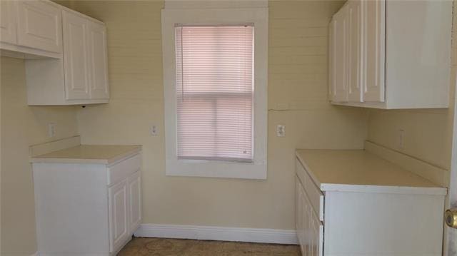 2607 Soniat St, New Orleans, LA 70115 - kitchen with light countertops and white cabinetry