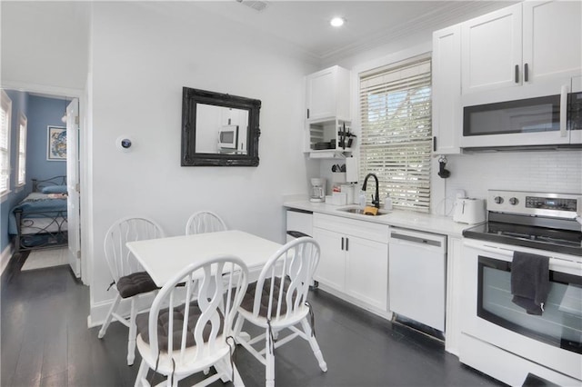 1030 Kerlerec St Unit 6, New Orleans, LA 70116 - kitchen with stainless steel appliances, a sink, white cabinets, tasteful backsplash, and crown molding