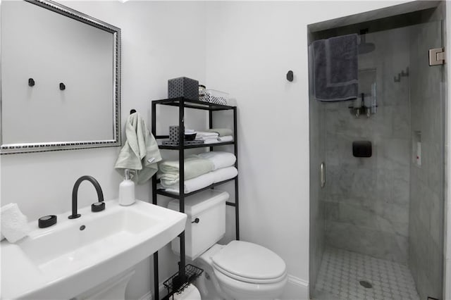 1030 Kerlerec St Unit 6, New Orleans, LA 70116 - bathroom featuring a sink, toilet, a stall shower, and baseboards