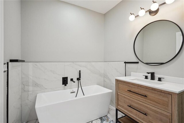 2327 Pauline St, New Orleans, LA 70117 - bathroom featuring marble finish floors, vanity, and a soaking tub