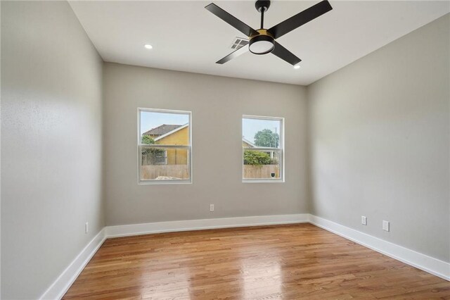 2327 Pauline St, New Orleans, LA 70117 - spare room featuring wood finished floors, ceiling fan, and recessed lighting
