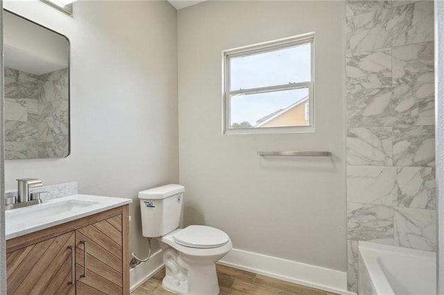 2327 Pauline St, New Orleans, LA 70117 - full bath with vanity, baseboards, toilet, and wood finished floors