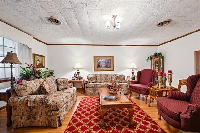 2108 Washington St, Franklinton, LA 70438 - living area featuring crown molding, wood finished floors, and a chandelier